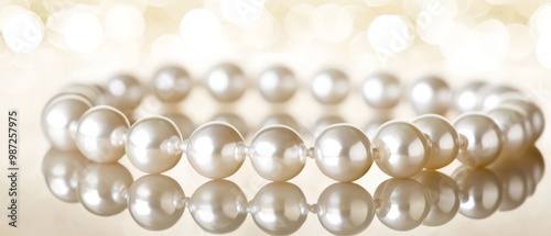  A tight shot of pearls clustered on a white backdrop, illuminated by soft bokeh lights in the background