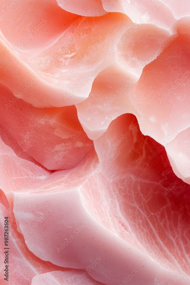 A tight shot of a meat slice, appearing divided, with pink and white hues A tight shot of a meat slice, appearing divided, with pink and white hues