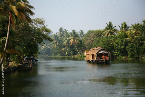 Traditional Indian houseboat sailing on a river in Kerala, India