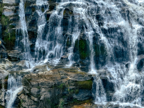 Aerial view of a waterfall in a lush tropical green forest in Doi Inthanon National Park, Chiang Mai, Thailand. This nature landscape showcases water sustainability and scenic travel destinations.