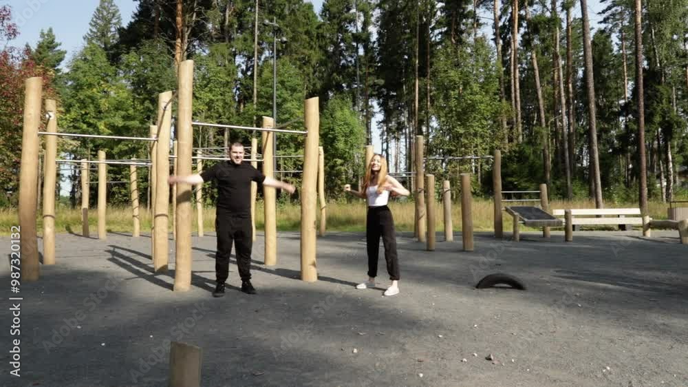 Workout, man and woman doing sports outdoors, fitness enthusiasts training with equipment, outdoor exercise in a public gym, active summer session in the park. Workout, man and woman doing sports outdoors, fitness enthusiasts training with equipment, outdoor exercise in a public gym, active summer session in the park.