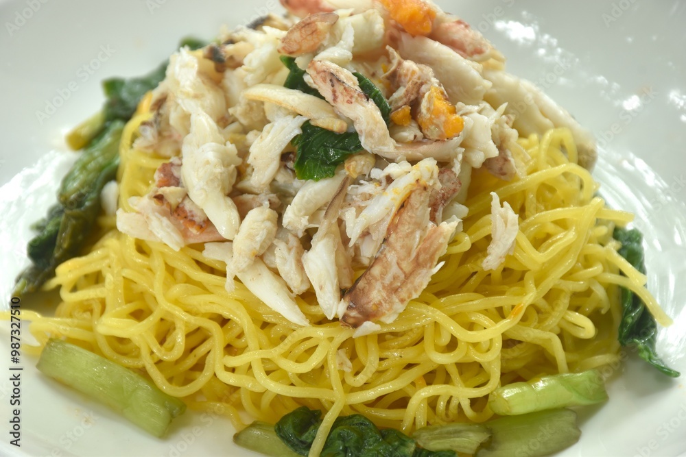 Chinese egg yellow noodles topping crab meat on plate Chinese egg yellow noodles topping crab meat on plate