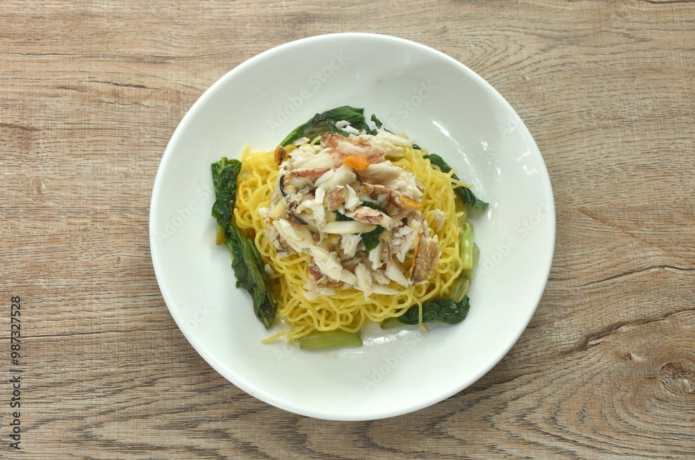 Chinese egg yellow noodles topping crab meat on plate Chinese egg yellow noodles topping crab meat on plate