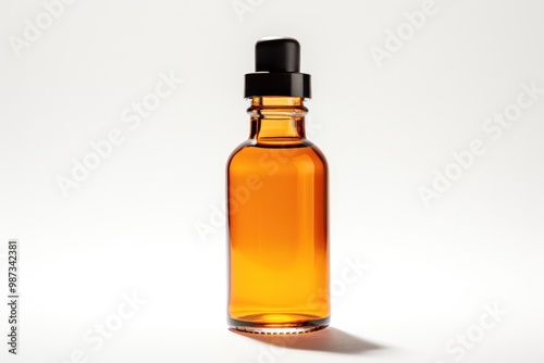 A high-key photograph of an amber glass dropper bottle, isolated on a bright white background. The bottle is illuminated with strong, direct light