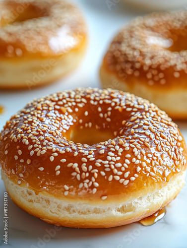 Glazed donuts with sesame seeds on a white background