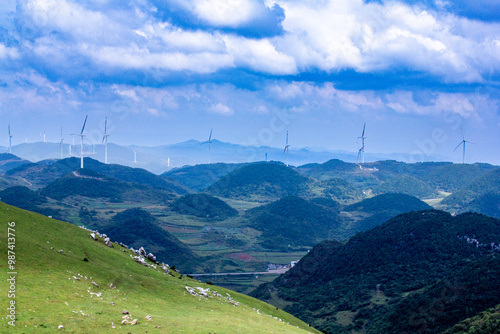 Wind turbines standing on the green prairie represent green environmental protection, sustainable development and protecting the earth