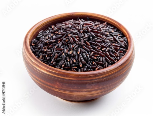 A bowl of black rice on a white background