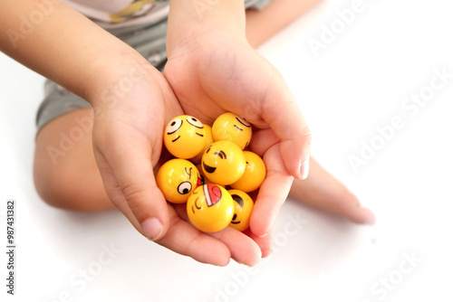 close up of a child's hand holding a mini ball of emotions