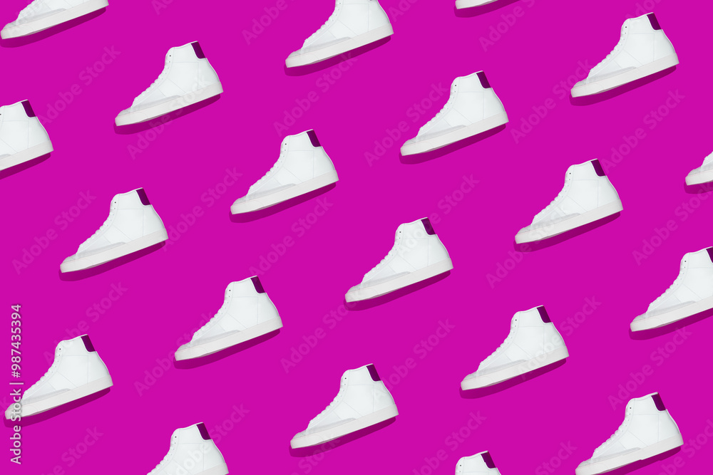 Obraz premium Pattern of white sneakers on bright purple background. Creative shoes concept