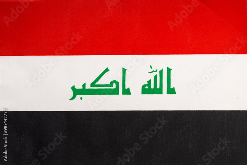 National flag of the state of Iraq close-up. State background. photo