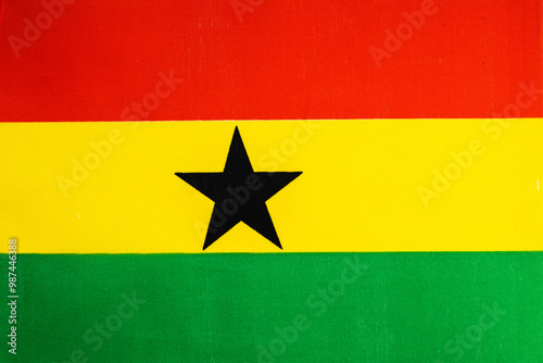 National flag of the state of Ghana close-up. State background.
