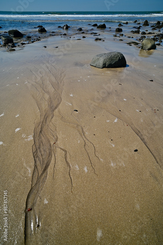 Patterns in sand on Kashid beach, India.  photo