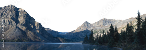 A large rocky mountain in the background with a glacier and a calm blue lake in the foreground. A treed shoreline fills the right side of the frame. The sky is transparent
