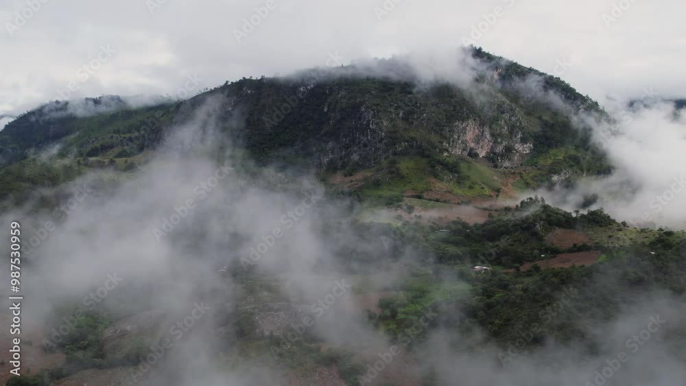 Flying over the clouds that reveal the peak of the mountain in the background. Flying over the clouds that reveal the peak of the mountain in the background.