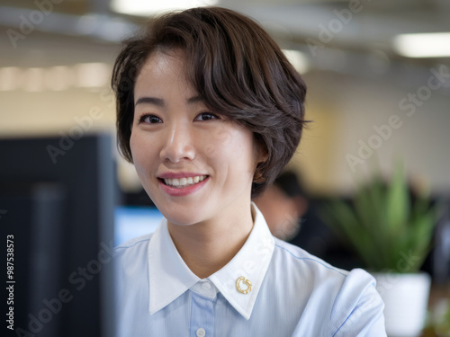 Happy businesswoman smiling. Smiling woman working in office, happy and confident, looking at camera.