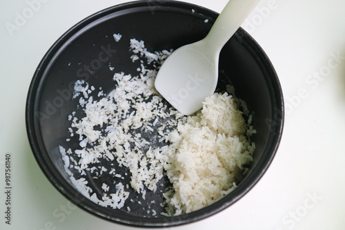 the remaining dried rice in the magic com. stale rice leftover in the rice cooker pot. photo