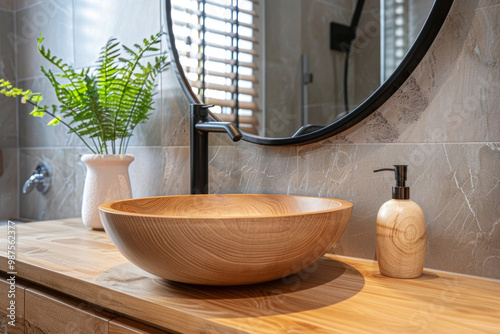 A beautifully designed wooden cabinet features round sink bowl and sleek faucet, complemented by stylish mirror. natural elements create serene and inviting atmosphere