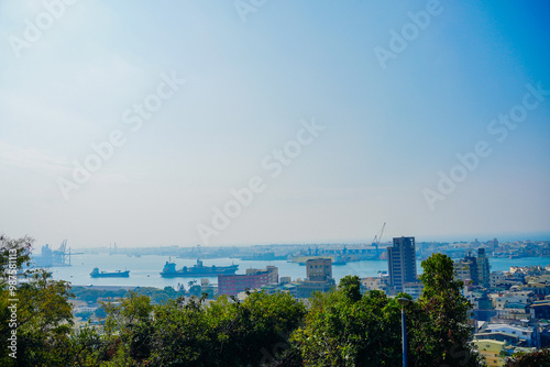 Kaohsiung, Taiwan, Republic of China, 01 25 2024: The landscape of Kaosiung port harbor, downtown, taiwan strait, and shoushan mountain  photo