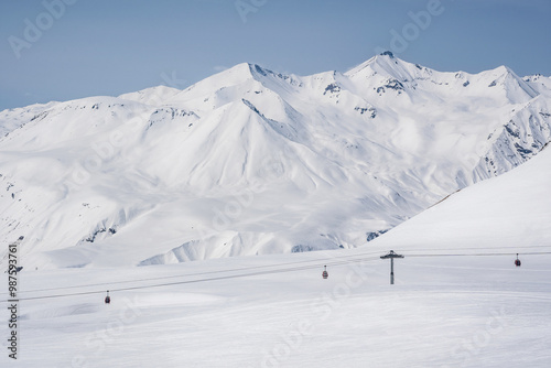 Snowy slopes with gondola to Kobi and ski tracks in nice sunny day. Ski resort Gudauri, Georgia. Caucasus Mountains. Aerial view. photo