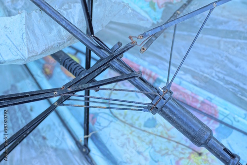 part of an old dirty umbrella with a broken black metal mechanism photo