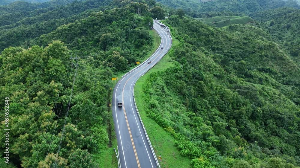 Aerial view over the winding mountain road No.3 during sunlight, The famous winding road in Nan Province, Thailand. Epic of winding road. nature, transportation and tourists concept. 4K
Aerial view over the winding mountain road No.3 during sunlight, The famous winding road in Nan Province, Thailand. Epic of winding road. nature, transportation and tourists concept. 4K