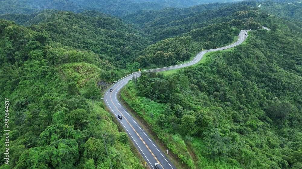 Aerial view over the winding mountain road No.3 during sunlight, The famous winding road in Nan Province, Thailand. Epic of winding road. nature, transportation and tourists concept. 4K
Aerial view over the winding mountain road No.3 during sunlight, The famous winding road in Nan Province, Thailand. Epic of winding road. nature, transportation and tourists concept. 4K