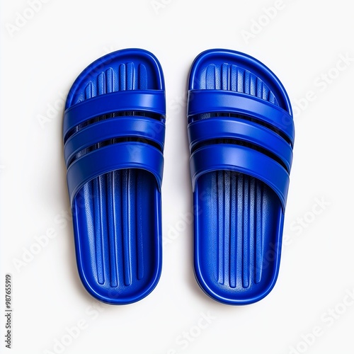 "Bright blue rubber slides on a white background, perfect for summer and casual wear. Comfort, leisure lifestyle concept."

