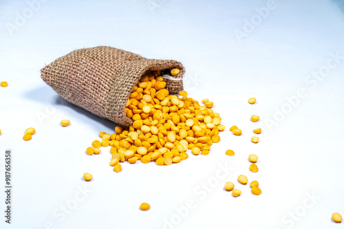 fresh split peas in jute sack on white background. Chana dal. split chickpea