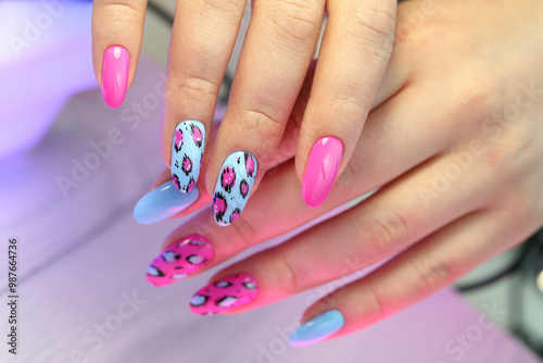 New Nail atrs on young women's hands. Manicured hands, pink nail art manicure