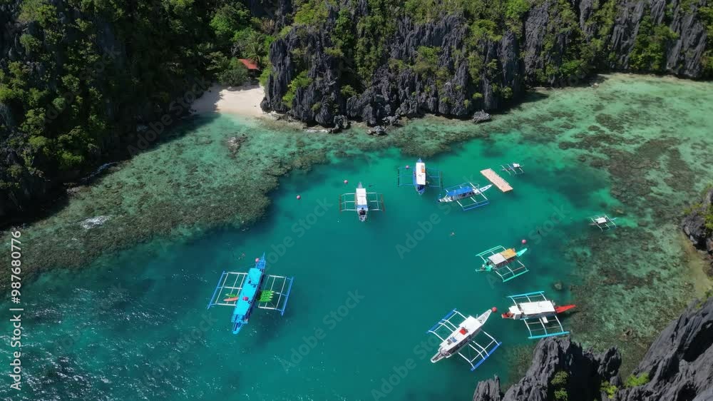 Aerial view of tropical island in Philippines. Boats in blue lagoons and lakes, white sand beach, rocks cliffs mountains and coral reef, 4k Aerial view of tropical island in Philippines. Boats in blue lagoons and lakes, white sand beach, rocks cliffs mountains and coral reef, 4k