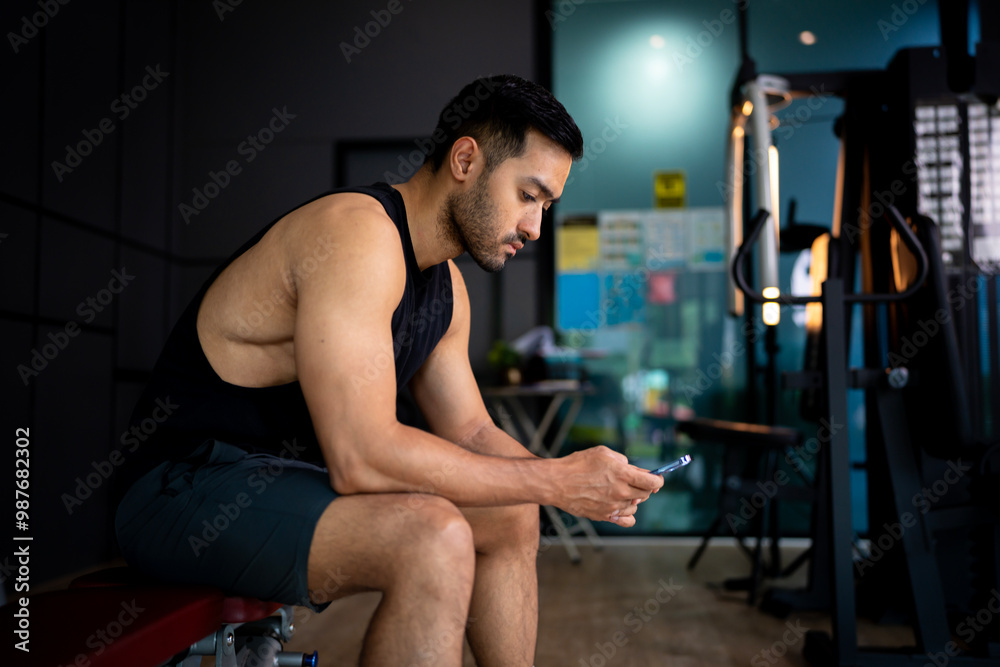 A strong Asian man is exercising to build muscle. A strong Asian man is exercising to build muscle.