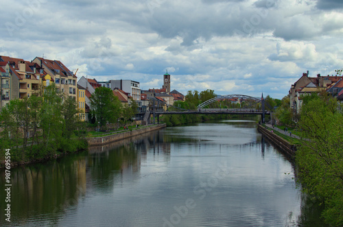 Landscape view of river Regnitz in down town of Bamberg,region Upper Franconia, Germany. Colorful houses along the river. Clouds reflected in tranquil water of the river. Travel and tourism concept