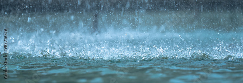 Heavy raindrops splashing on the ground photo