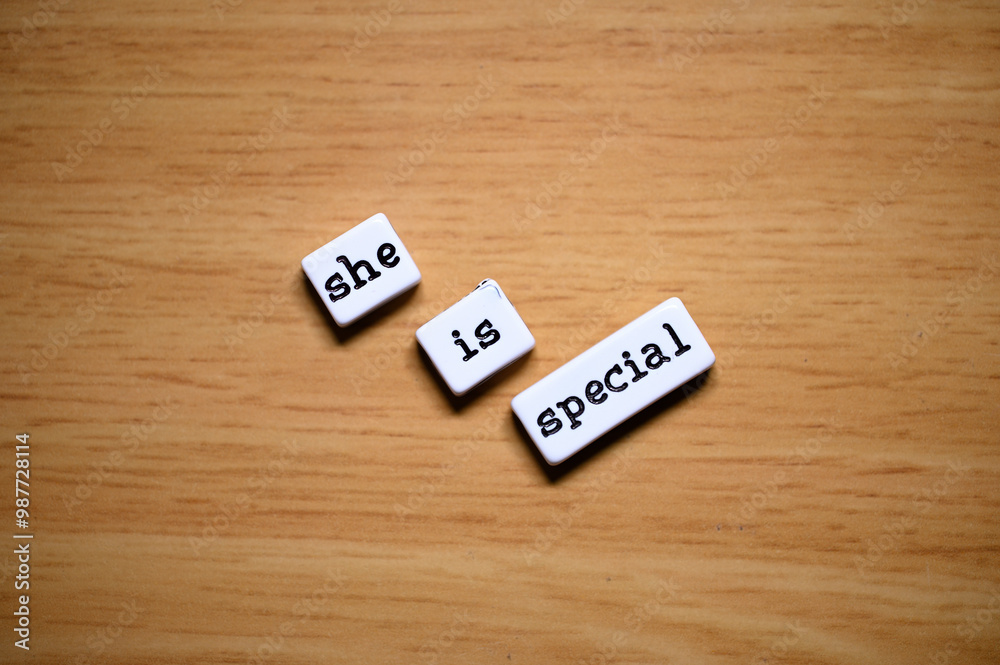 love expression: blocks with the words 'she', 'is', and 'special' placed on a wooden surface.