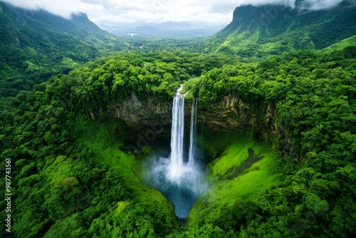 A waterfall in a tropical rainforest, surrounded by lush green vegetation, symbolizing the richness of natural ecosystems