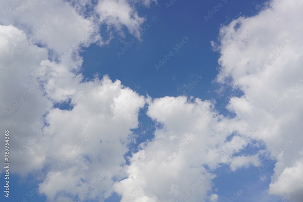 Fototapeta premium A blue sky with a white clouds with a sun light.