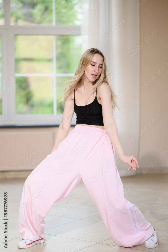 Full length view of happy woman dancing and singing in room filled with light. Musical concept, dancing. Dancer enjoying life, expressing happiness. Vertical Full length view of happy woman dancing and singing in room filled with light. Musical concept, dancing. Dancer enjoying life, expressing happiness. Vertical