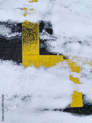 Snowflakes on grey street with yellow lines, winter day street with space for text, no person