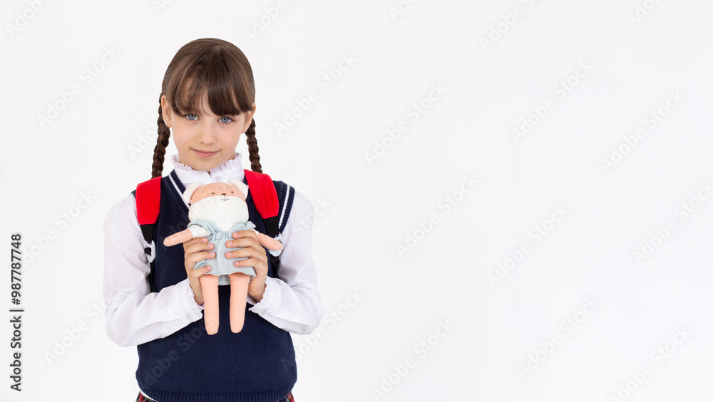Portrait of satisfied pleasant teen girl wear school uniform embrace fox toy isolated on white background Portrait of satisfied pleasant teen girl wear school uniform embrace fox toy isolated on white background