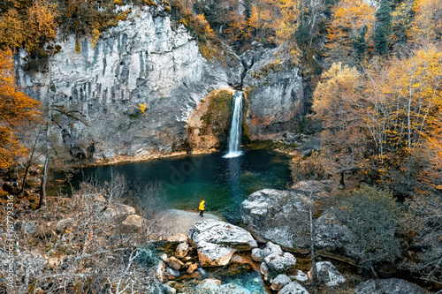 Ilica Waterfall. Magnificent view of water coming naturally from the mountain. Man in yellow coat watching the waterfall. Drone shot. Kastamonu, Turkey. photo