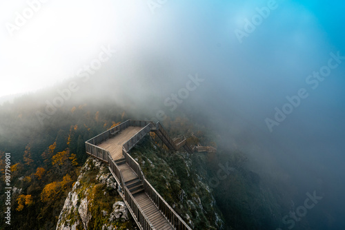 Valla Canyon. Wooden stairs on the mountain to go up to the canyon. Perfect drone photo with the view of autumn leaves and foggy weather. Kastamonu, Turkey. photo