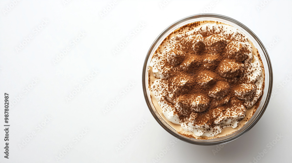 Layers of creamy Tiramisu with espresso-soaked ladyfingers and a dusting of cocoa powder, served in a glass dish Layers of creamy Tiramisu with espresso-soaked ladyfingers and a dusting of cocoa powder, served in a glass dish