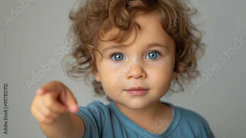 Playful Toddler Pointing with a Smile