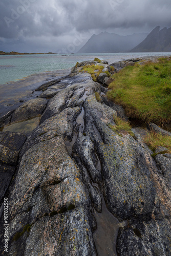 Thr rocky and mountainous terrain and shore of Gimsoy in the Lofoton Islands, Norway.  photo