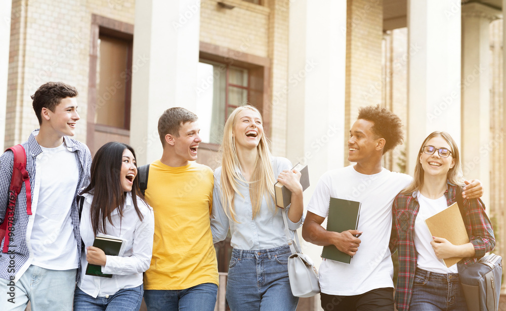 Fototapeta premium Happy students walking together in campus, having break in university