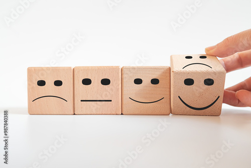 Customer hand turning unhappy expression into happy expression.Customer service evaluation and satisfaction survey.