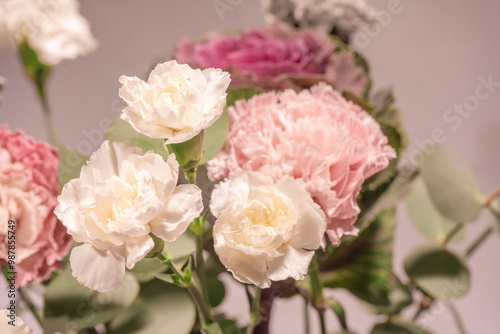 Beautiful bouquet of pink, grey and white carnation flowers, fresh eucalyptusas and violet brassica flower.