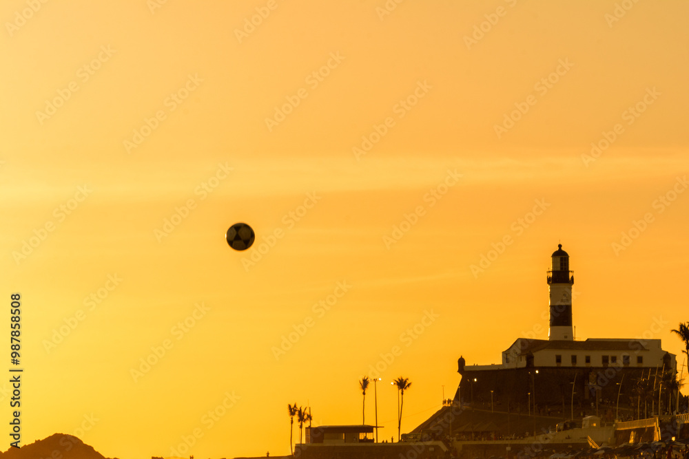 Φωτογραφία Bathers are seen playing beach soccer during sunset on Farol da Barra beach in the city of Salvador, Bahia