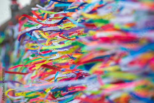 Several colorful ribbons of remembrance attached to the fence of the Senhor do Bonfim church in the city of Salvador, Bahia. photo