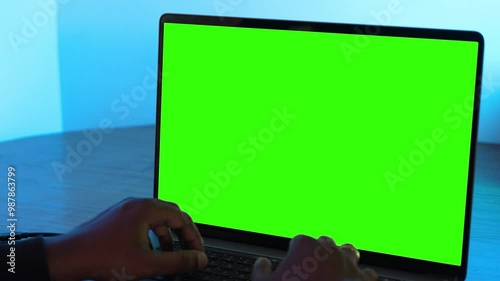 a person working on a laptop. Green screen. chroma key. mockup computer